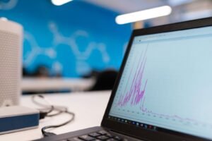Laptop displaying a data analytics graph in a modern office